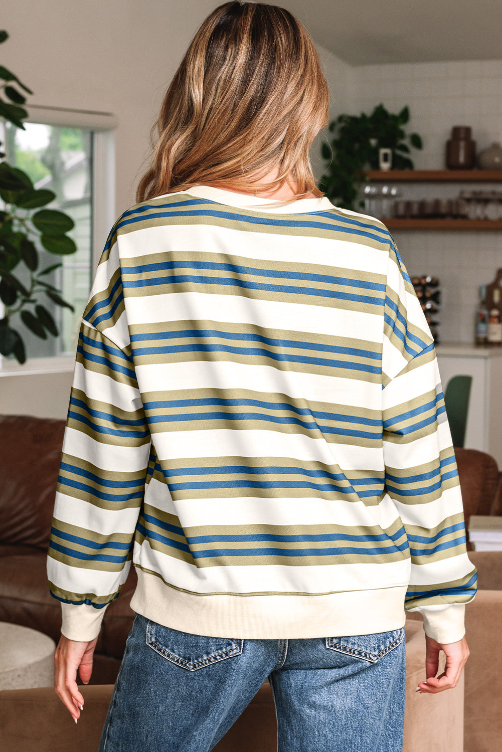 Back view of the cream striped crewneck sweatshirt