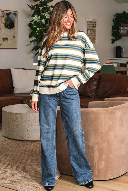 Full length view of the striped sweatshirt with wide-leg jeans
