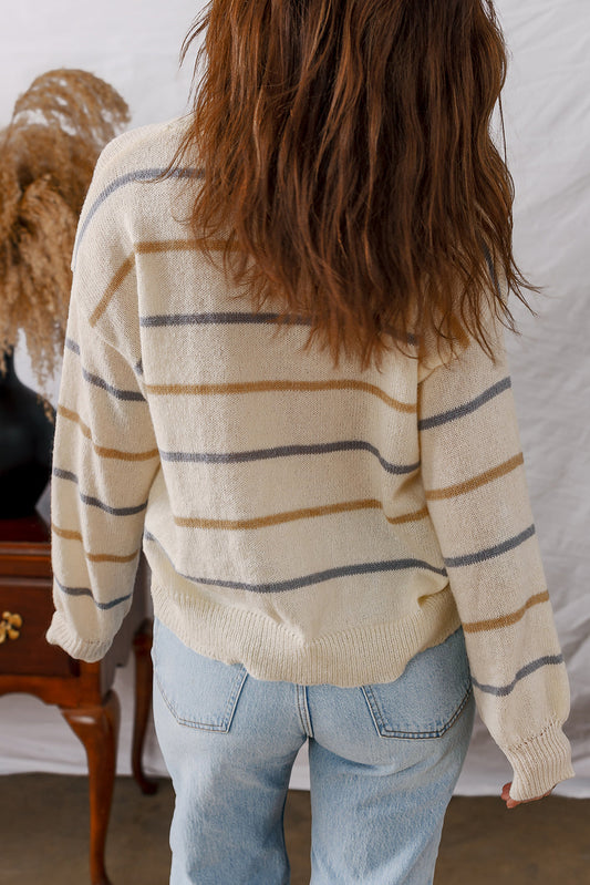 Back view of the cream striped drop shoulder sweater