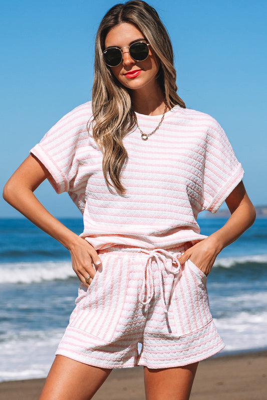 Pink and white striped knit tee and shorts set on a beach, front view