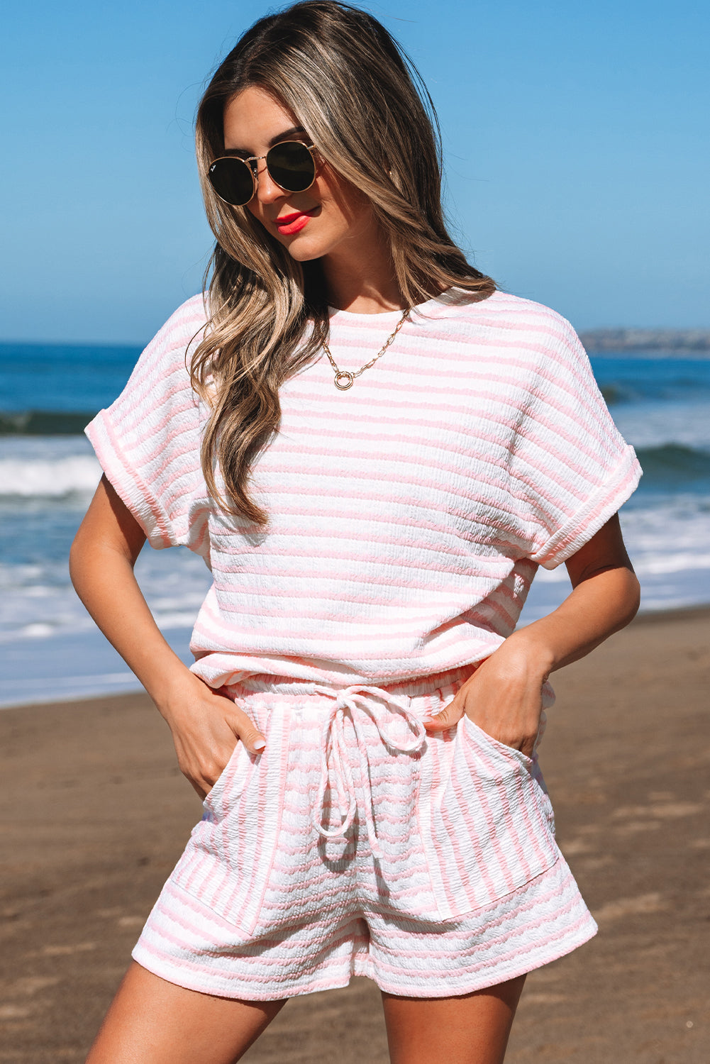 Pink striped textured knit set, hands in the shorts pockets