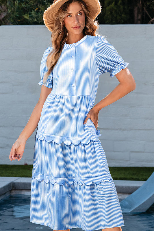 Light blue striped tiered midi dress with scallop trim by a pool