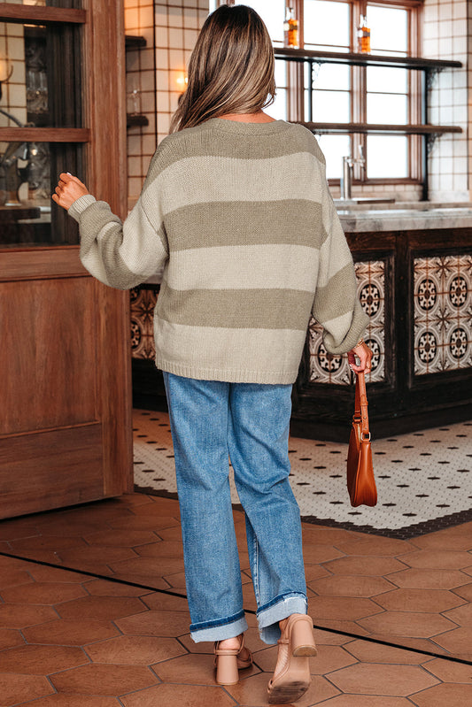 Back view of the khaki striped cardigan, model walking