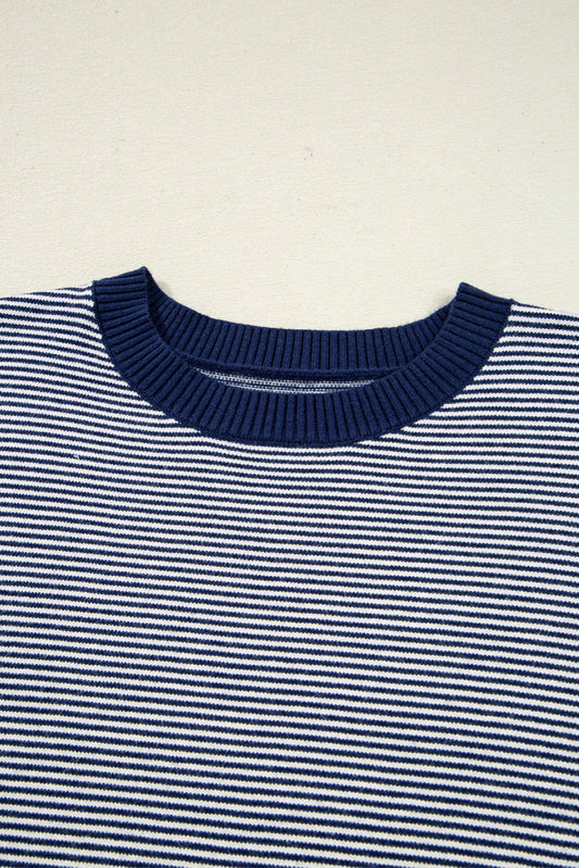 Close-up of the navy ribbed crew neckline on the pinstripe knit