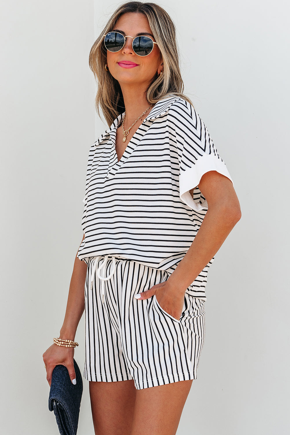 Three-quarter view of the striped set, hand in the shorts pocket