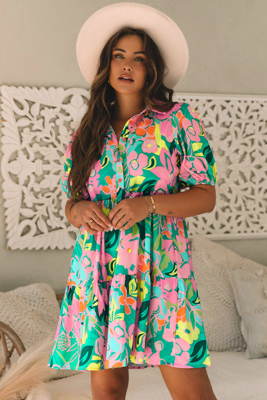 Green tropical floral babydoll dress with puff sleeves, model in a cream hat