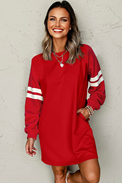 Red sweatshirt dress with white varsity stripes on a model