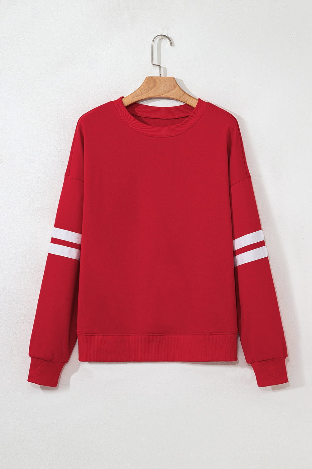 Red varsity stripe sweatshirt on a hanger