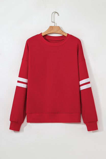 Red varsity stripe sweatshirt on a hanger